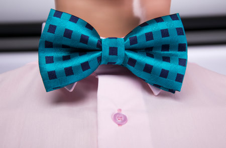 Pink shirt and green bow tie placed on a mannequinの写真素材