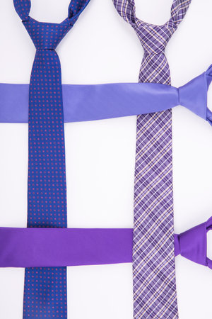 Four tie in shades of purple on a white background. Top viewの写真素材