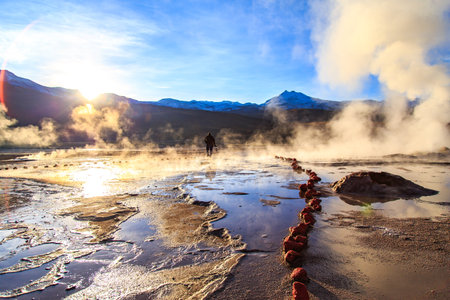 El Tatio Geyser site, San Pedro de Atacama with tourists visiting. Photographer at El Tatio geysers, Chile at sunriseの写真素材