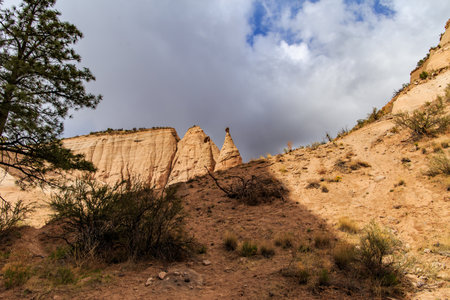Landscape of rock formations against dark stormy sky in Kasha-Katuwe Tent Rocks National Monument in New Mexico, USAの写真素材