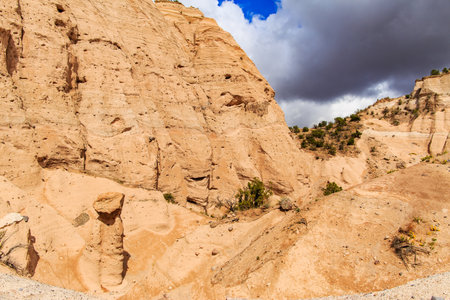 Landscape of rock formations against dark stormy sky in Kasha-Katuwe Tent Rocks National Monument in New Mexico, USAの写真素材