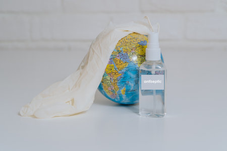 Help antiseptic in the epidemic . The globe is treated with an antiseptic in disposable gloves....