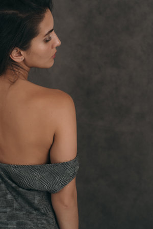 Sensual portrait of a beautiful girl. Vertical photo of a beautiful and stylish girl. Place for a text about cosmetologyの写真素材