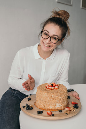 The pastry chef holds a mixer in his hands. A housewife prepares a cake. Portrait of a pastry chef at workの写真素材