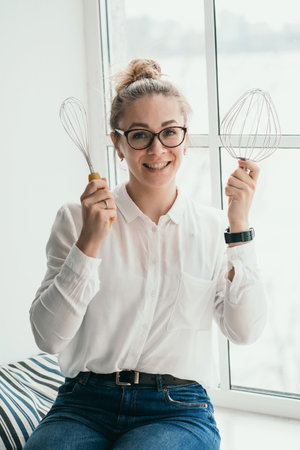 The pastry chef holds a mixer in his hands. A housewife prepares a cake. Portrait of a pastry chef...