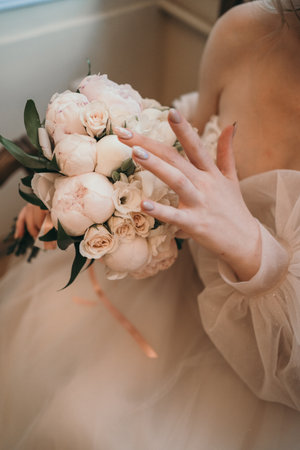 Delicate bouquet of the bride with peonies and roses. Close-up wedding bouquet. Bush roses in the brides bouquetの写真素材