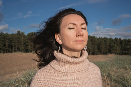 The brunette closed her eyes and enjoyed the sun. Thanks for a wonderful day. The girl meditates in...