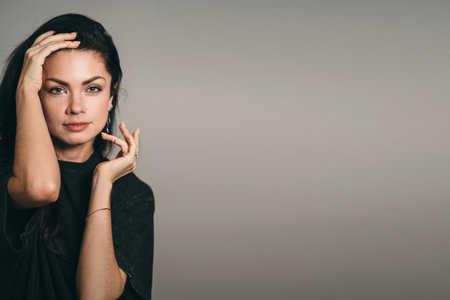 A place for a text about skin care. Beautiful girl with dark hair. Care for womens beauty. Caring for a woman after thirtyの写真素材