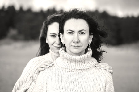 conceptual portrait of two friends. a strong bond between the siblings. support of relatives at any time of life. the value of family relationships. love between two girlsの写真素材
