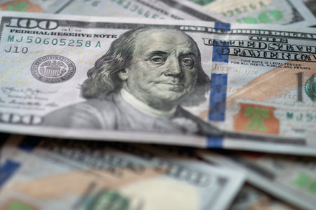 US fiat money pile, hundred dollar bills with Franklin closeup