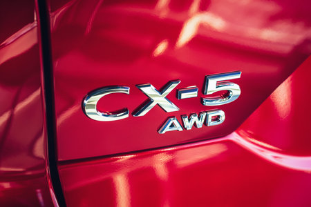 Mazda CX-5 AWD emblem on red crossover back door close-up, Moscow, 18 Feb 2021