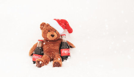 Coca cola for teddy bear in red santa hat, Christmas kids party invitation design, Moscow, 4 Dec 2021のeditorial素材