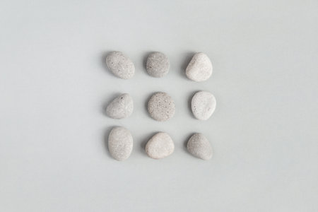 Pebble stones on light gray background, minimal design flat layの写真素材