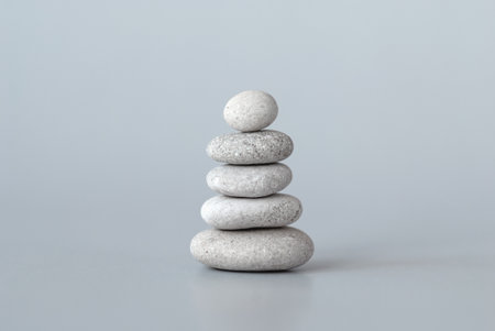 Pebbles stack on gray background, zen balance meditation minimal conceptの写真素材