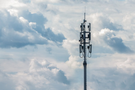 Cellular network transmitter tower on cloudy sky background, copy spaceの写真素材