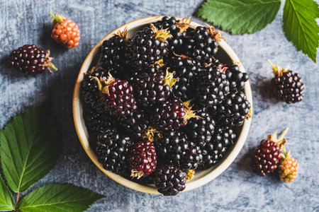 Blackberry fruits on in a bowl, food background, ripe blackberries closeupの写真素材