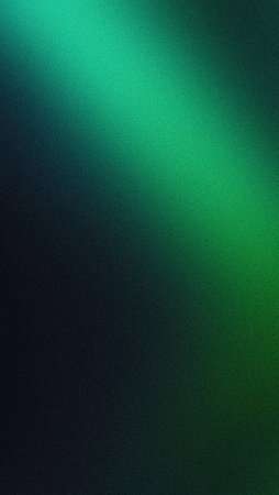 Glowing green blurred light gradient dark grainy black vertical background glowing light spot copy spaceの写真素材