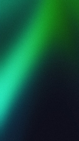 Vertical grainy green dark background glowing blurred light gradient black green mobile wallpaper bannerの写真素材