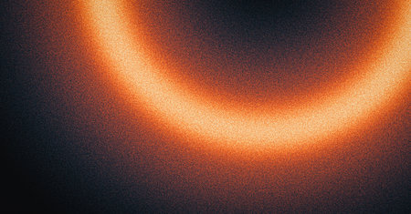Glowing burning fire ring dark background, grainy gradient orange red yellow black noise texture banner abstract backgroundの写真素材