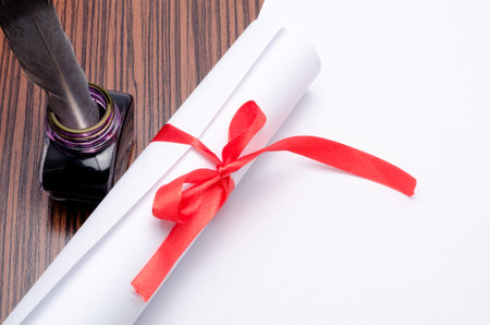 parcel with a feather and an inkwell on a table
