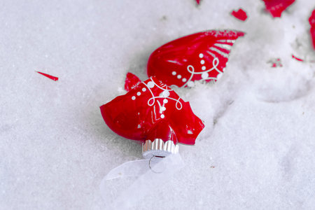 broken toy in the form of a heart in the snowの写真素材