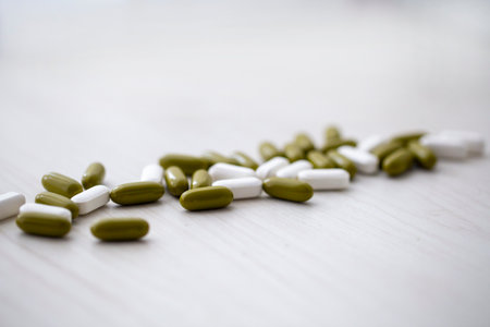 multi-colored pills dietary Supplements on a wooden tableの写真素材