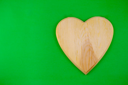 wooden heart for the entries on a green backgroundの写真素材