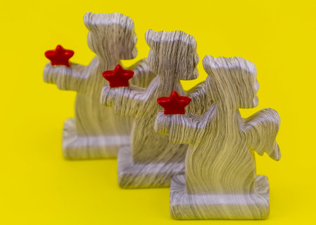 figures of angels with hearts on a yellow background