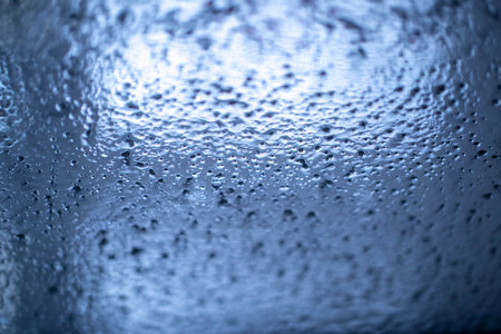the texture of the flowing water on the glass of the car during the car wash with various highlights and shadows,の写真素材