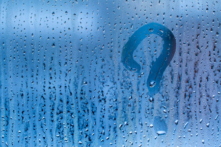 picture of question mark on wet glass close-up