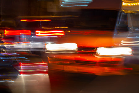 night traffic of cars in a blur, the lights from cars and flashlights at night の写真素材
