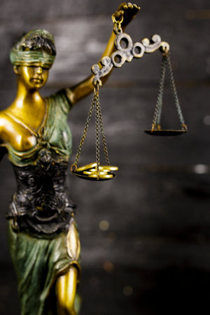 The Statue of Justice - lady justice or Iustitia / Justitia the Roman goddess of Justice  with money for finance concept.Law and Justice Themeの写真素材