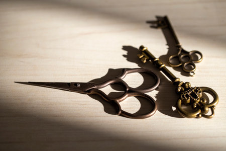 retro keys and scissors in the background light from the window on the wooden surface, deep shadows