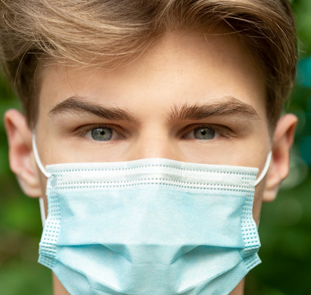 teenager in the mask in a pandemic coronavirus, close-upの写真素材