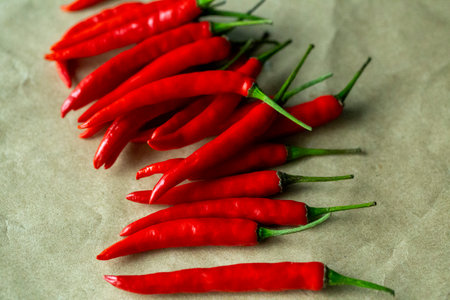 red chili pepper on a wooden table surface close-up