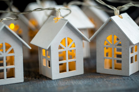 Christmas decor wooden garland with light on dark wood surface close upの写真素材