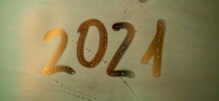 new year's numbers 2021 written on a fogged bathroom window in partial blur, close-upの写真素材