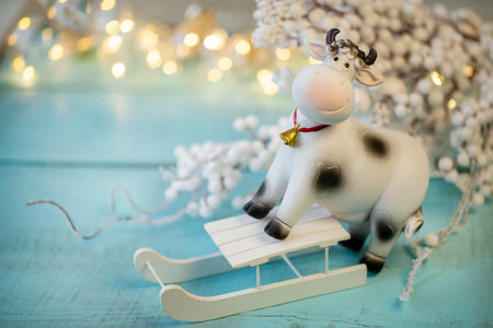 decorative cow symbol of 2021 on a light wooden surface, Christmas decorの写真素材