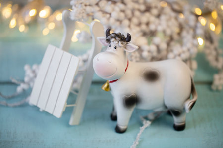 decorative cow symbol of 2021 on a light wooden surface, Christmas decorの写真素材