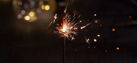 burning Sparkler on a dark wooden background close-up