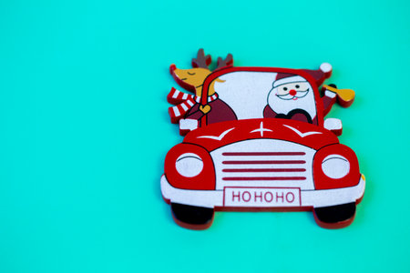 decor red Santa Claus car on a solid turquoise background close upの写真素材