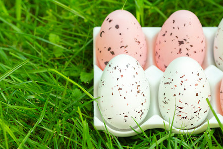 Easter colorful eggs on green grass, close-up