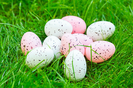 Easter colorful eggs on green grass, close-up