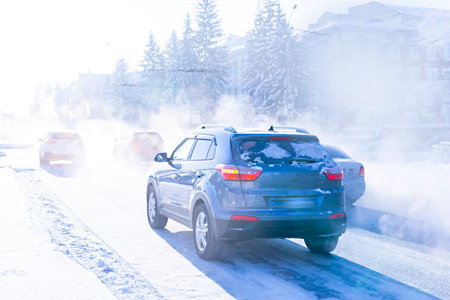 air pollution from the exhaust of cars in the city during the cold day, environmental pollution in...