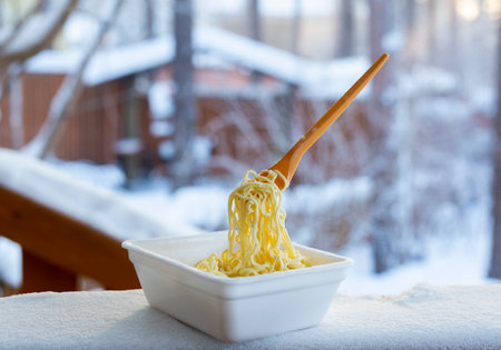frozen noodles on a fork on a very cold day in Siberia, cold temperature