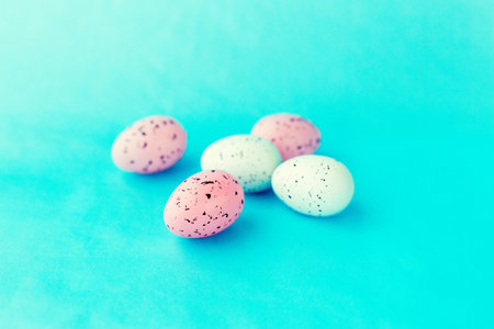 bright easter eggs on a blue plain surface, easter decor, close-upの写真素材