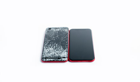 broken phone on a white background, broken electronics close-up