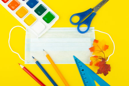 school supplies top view on a yellow background, with a place to write, close-up