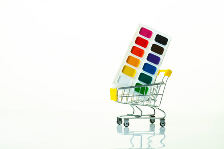 school paints in a grocery cart on a light background with reflection, close-upの写真素材