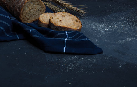 A loaf of fresh bread made from rye flour. Bread cut into slices.